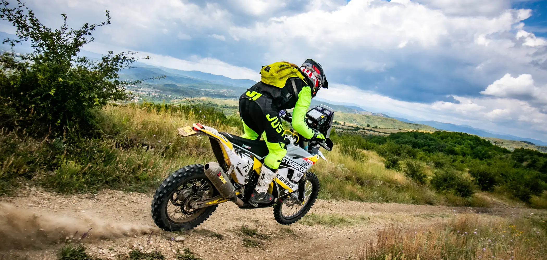 Jasmin Riccius on a rally stage above a wide valley