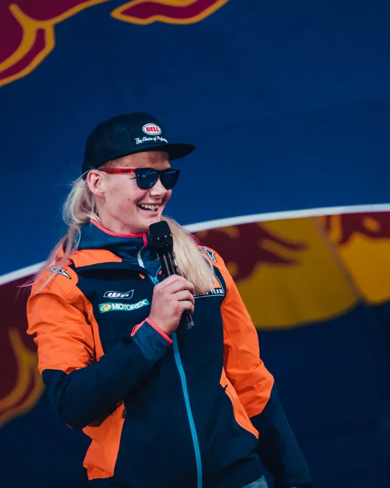 Jasmin Riccius on stage with a microphone at a Red Bull event
