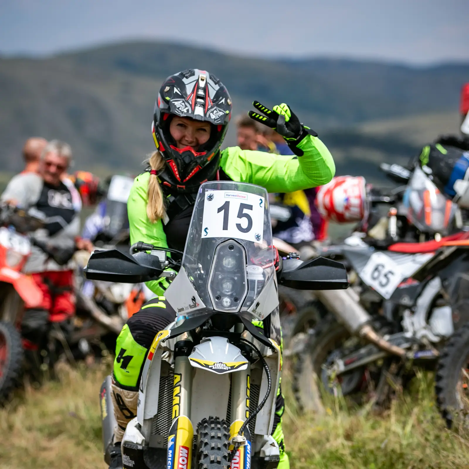 Jasmin Riccius on the start line with race number 15, waving at the camera