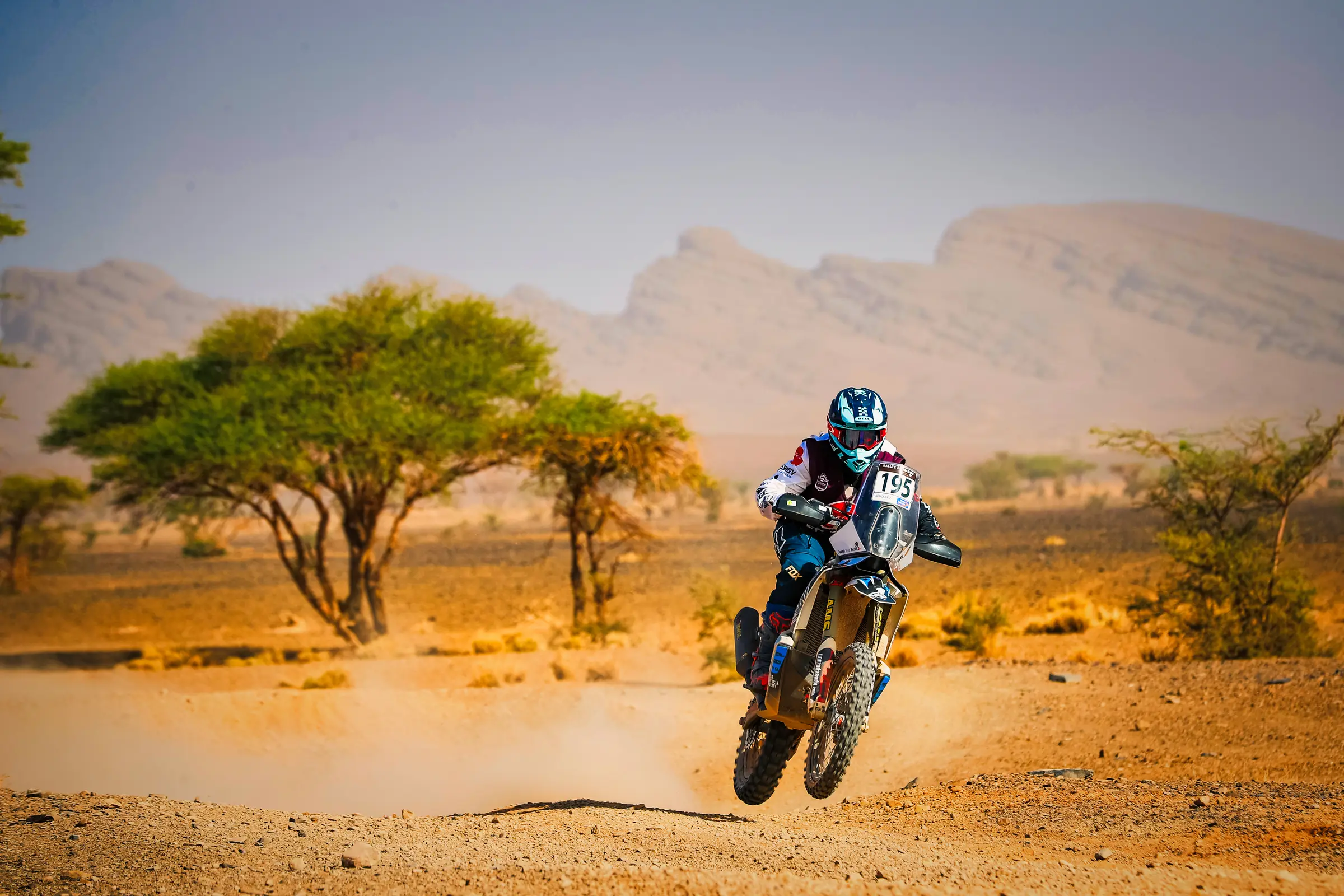 Jasmin Riccius riding through the Moroccan desert with race number 195